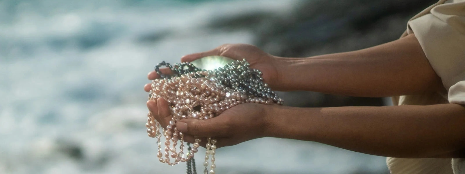 Holding a strand of pearls